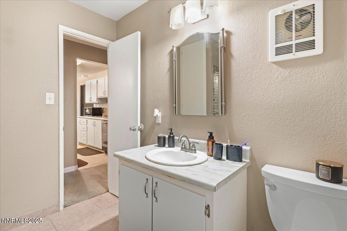 3941 Clear Acre Lane, Unit 237 Reno, NV 89512 - Photo 17 of 26 a bathroom with a sink a toilet and shower
