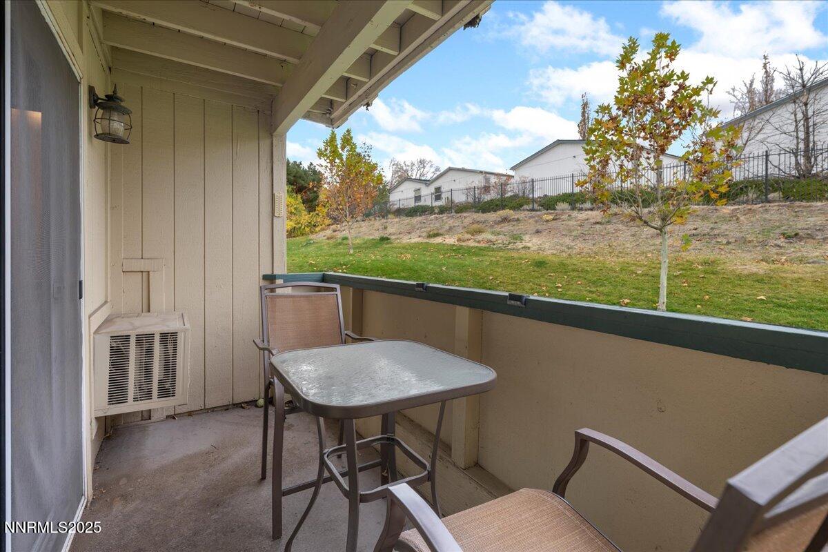 3941 Clear Acre Lane, Unit 237 Reno, NV 89512 - Photo 6 of 26 a view of balcony with a table and chairs