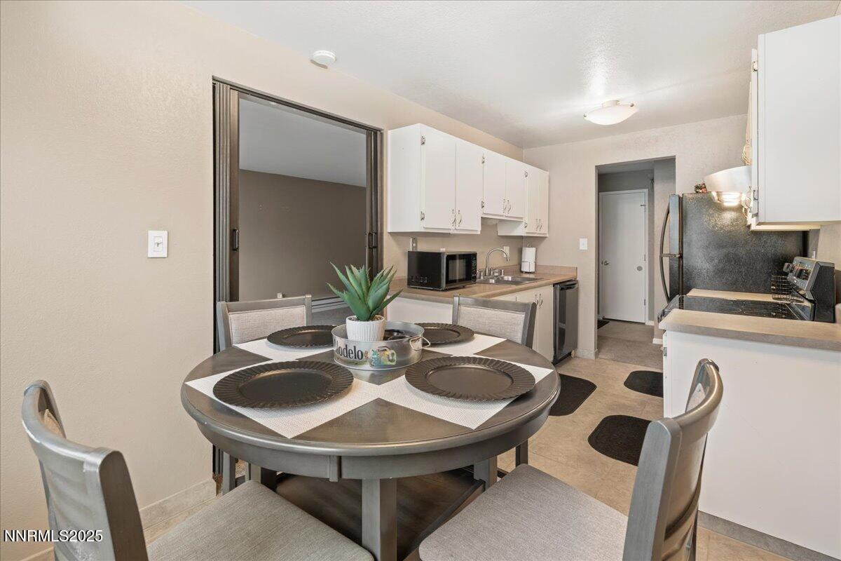 3941 Clear Acre Lane, Unit 237 Reno, NV 89512 - Photo 9 of 26 a kitchen with a dining table and chairs