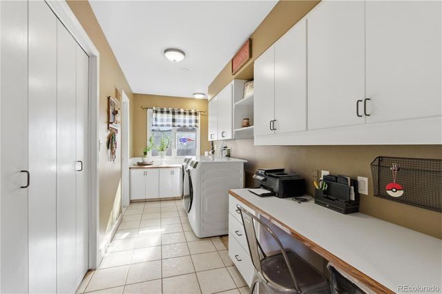a kitchen with a refrigerator and cabinets