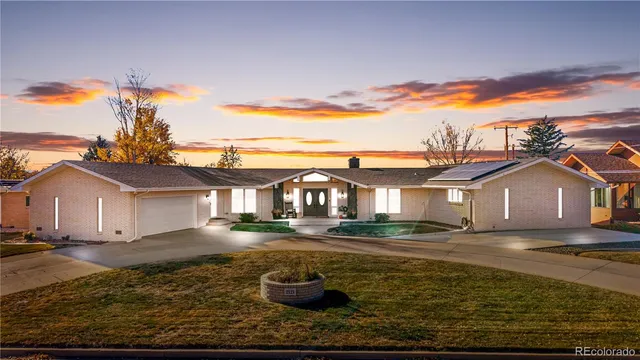 a dining room with furniture a chandelier and wooden floor
