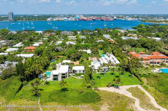 an aerial view of a house with a yard and lake view