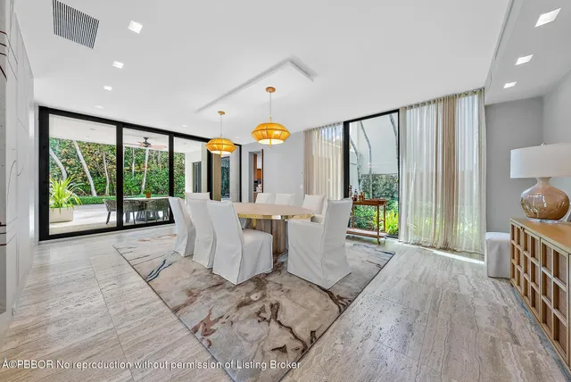 a living room with fireplace furniture and a large window