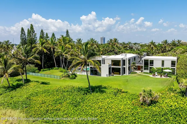 a view of a house with a big yard and large trees