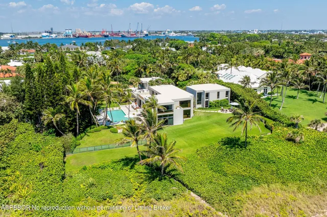 a aerial view of a house with a yard and lake view