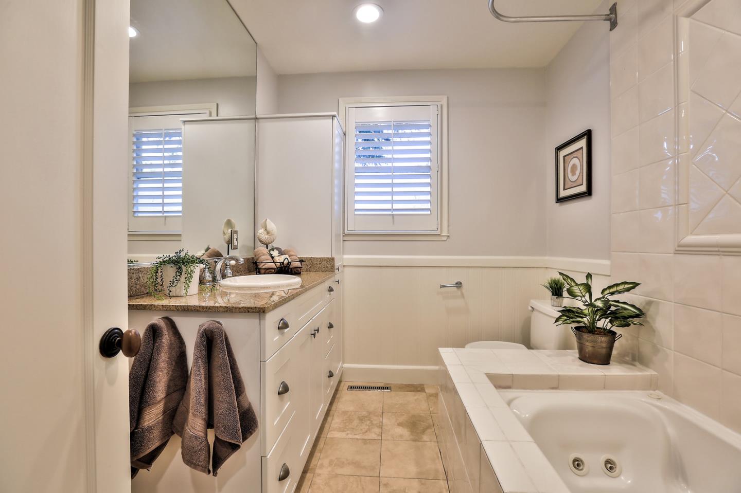 525 Alhambra Road San Mateo, CA 94402 - Photo 14 of 39 a bathroom with a tub sink and mirror