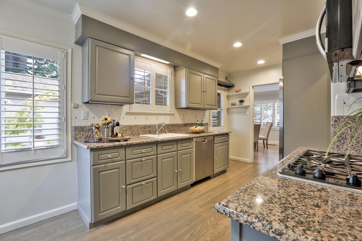 525 Alhambra Road San Mateo, CA 94402 - Photo 31 of 39 a kitchen with stainless steel appliances granite countertop a stove a sink and a refrigerator