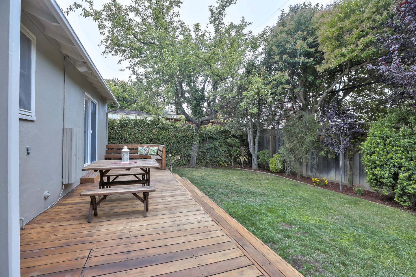 525 Alhambra Road San Mateo, CA 94402 - Photo 35 of 39 a view of a deck with chairs and a yard