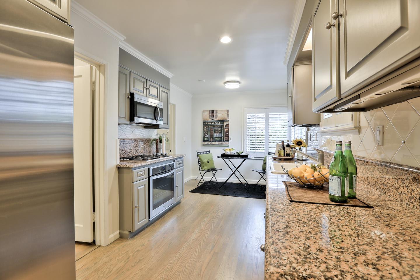 525 Alhambra Road San Mateo, CA 94402 - Photo 8 of 39 a kitchen with stainless steel appliances granite countertop lots of counter top space