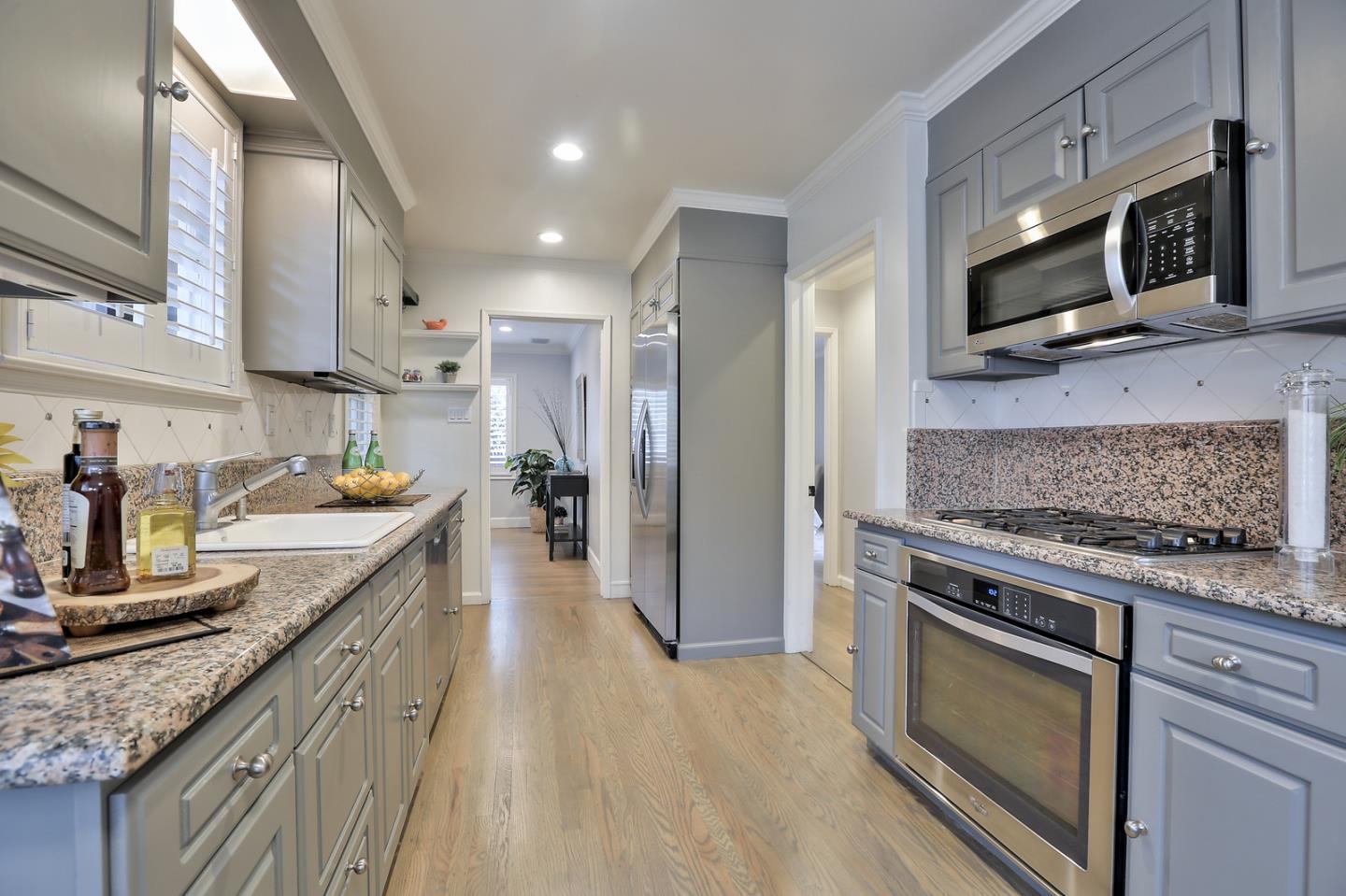 525 Alhambra Road San Mateo, CA 94402 - Photo 10 of 39 a kitchen with stainless steel appliances granite countertop a stove a sink and a microwave