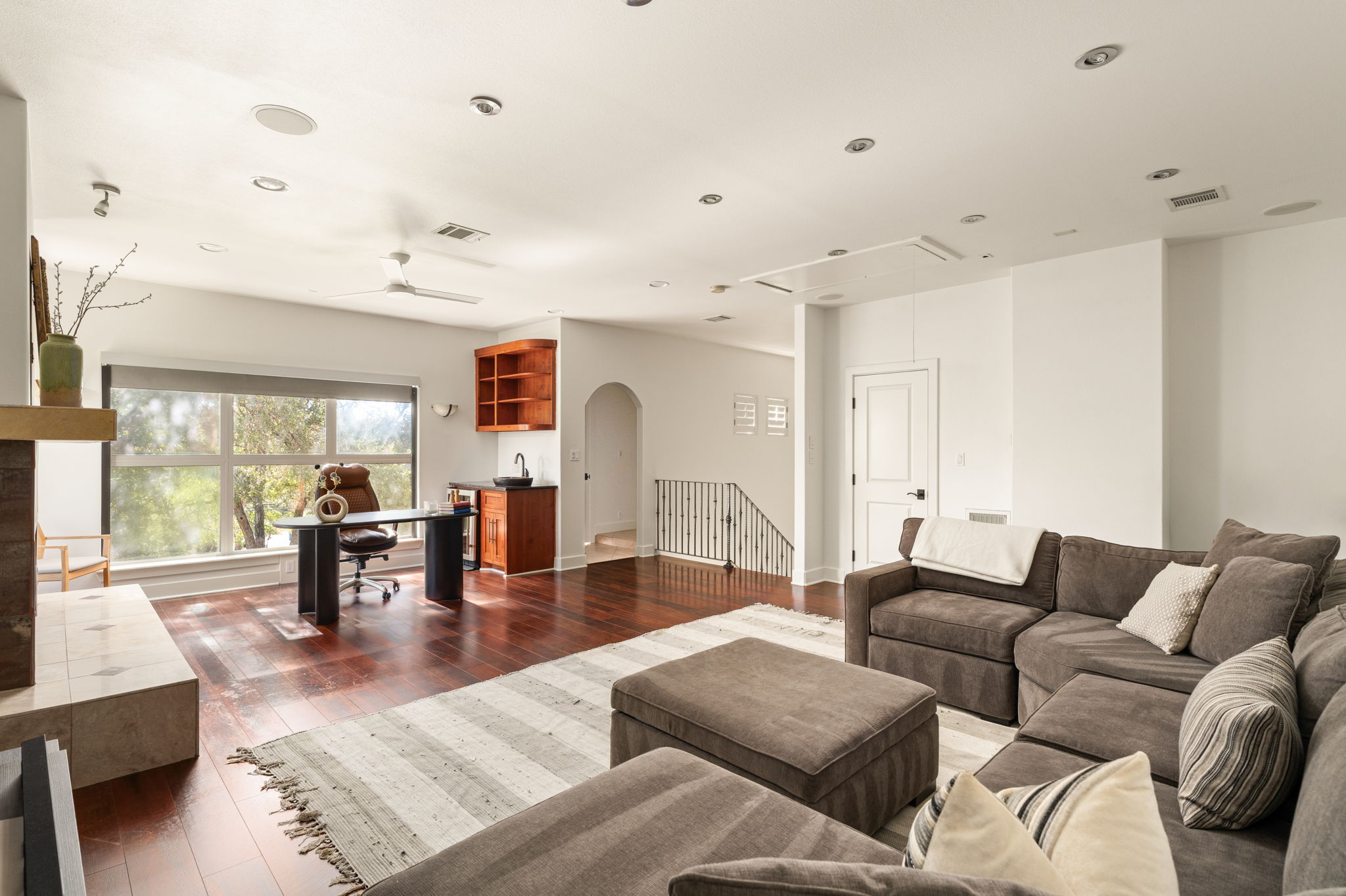 2324 Kinney Road Austin, TX 78704 - Photo 28 of 35 Gleaming hardwood floors and a tiled fireplace hearth anchor this versatile, open living area.