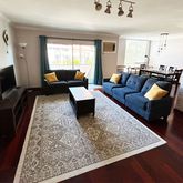 a living room with furniture and a rug