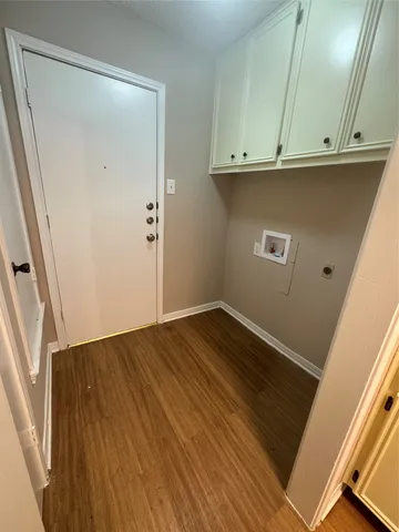 an empty room with wooden floor and a window