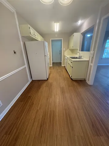 a living room with wooden floors and pool table