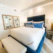 a bed sitting in a bedroom with a large window