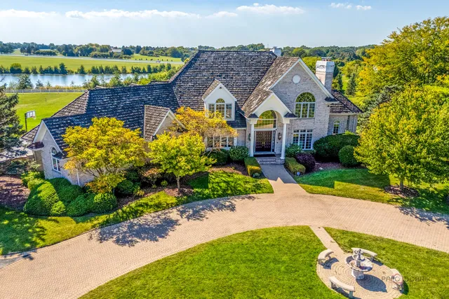 an aerial view of a house with a swimming pool patio and outdoor seating
