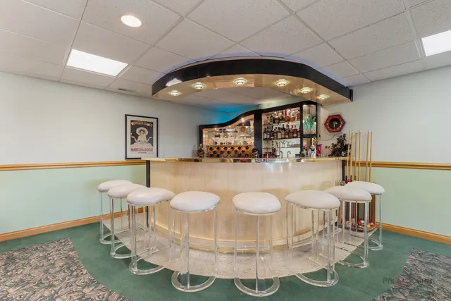 a living room with furniture a chandelier and a wooden floor