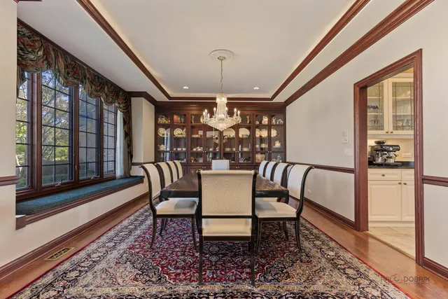 a kitchen with stainless steel appliances granite countertop sink table and chairs