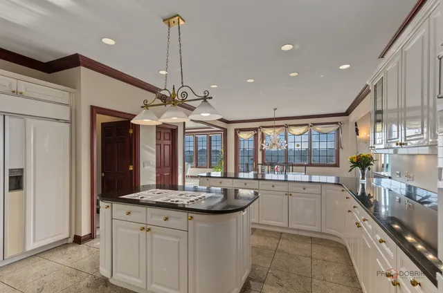 a kitchen with granite countertop a stove and a sink