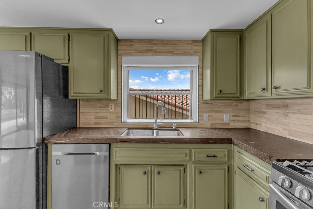 67525 Monterey Road Desert Hot Springs, CA 92240 - Photo 15 of 75 a kitchen with granite countertop a sink cabinets and stainless steel appliances