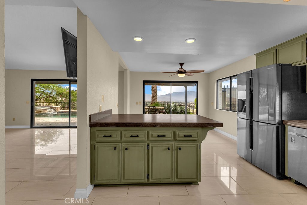 67525 Monterey Road Desert Hot Springs, CA 92240 - Photo 25 of 75 a kitchen with a refrigerator and a sink