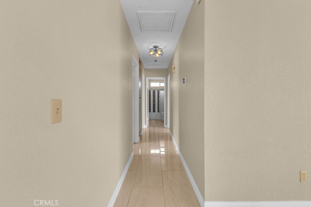 67525 Monterey Road Desert Hot Springs, CA 92240 - Photo 26 of 75 a view of a hallway with wooden floor
