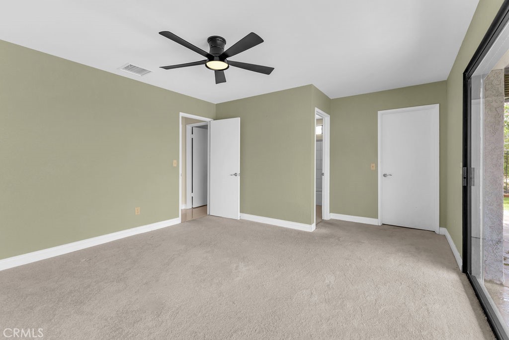 67525 Monterey Road Desert Hot Springs, CA 92240 - Photo 29 of 75 an empty room with closet and a chandelier fan