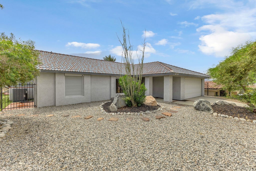 67525 Monterey Road Desert Hot Springs, CA 92240 - Photo 3 of 75 a front view of a house with a yard and garage