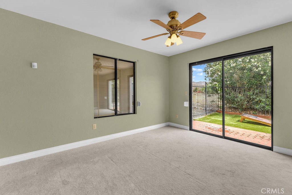 67525 Monterey Road Desert Hot Springs, CA 92240 - Photo 35 of 75 an empty room with window and a ceiling fan