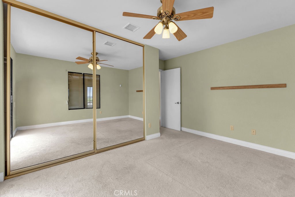 67525 Monterey Road Desert Hot Springs, CA 92240 - Photo 36 of 75 a view of an empty room with a chandelier fan
