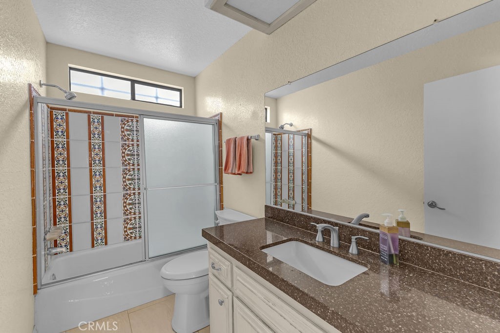 67525 Monterey Road Desert Hot Springs, CA 92240 - Photo 37 of 75 a bathroom with a granite countertop sink and a mirror