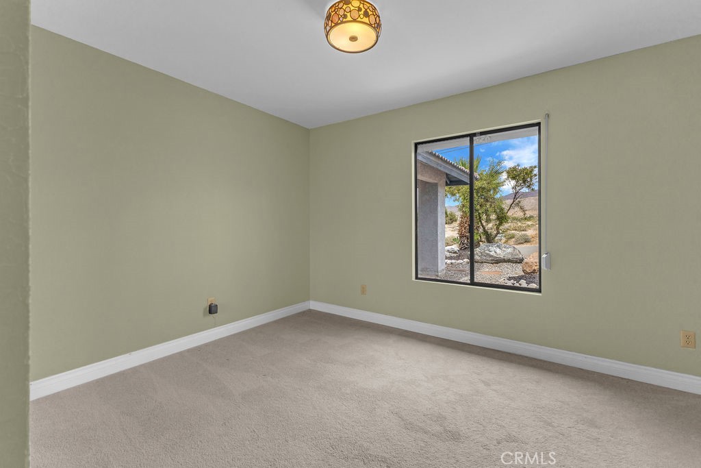 67525 Monterey Road Desert Hot Springs, CA 92240 - Photo 38 of 75 an empty room with a window and mirror