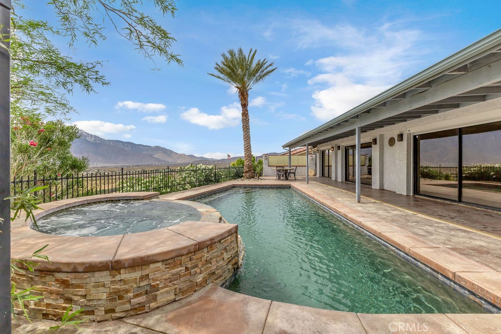 67525 Monterey Road Desert Hot Springs, CA 92240 - Photo 46 of 75 a view of a swimming pool with a yard
