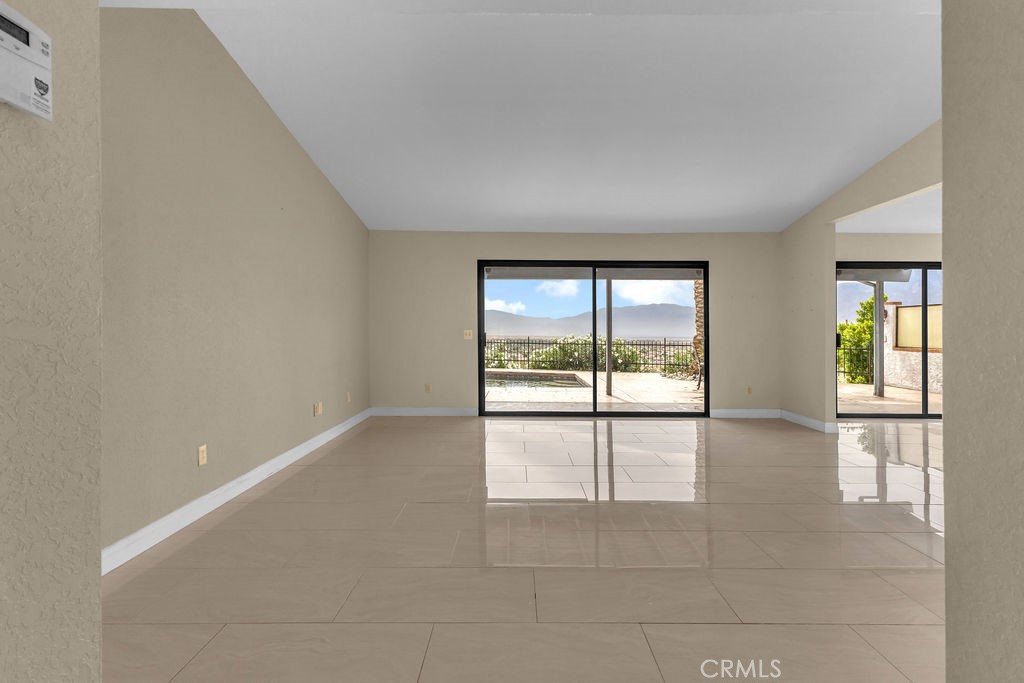 67525 Monterey Road Desert Hot Springs, CA 92240 - Photo 5 of 75 an empty room with large windows and mountain view