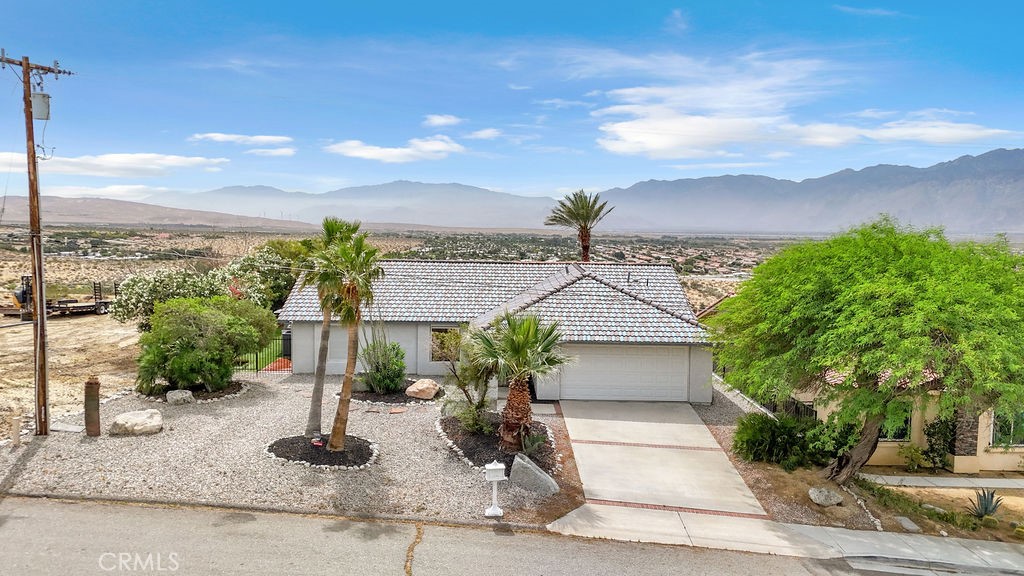 67525 Monterey Road Desert Hot Springs, CA 92240 - Photo 62 of 75 a front view of a house with garden
