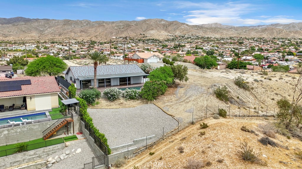 67525 Monterey Road Desert Hot Springs, CA 92240 - Photo 65 of 75 an aerial view of residential houses with outdoor space and trees