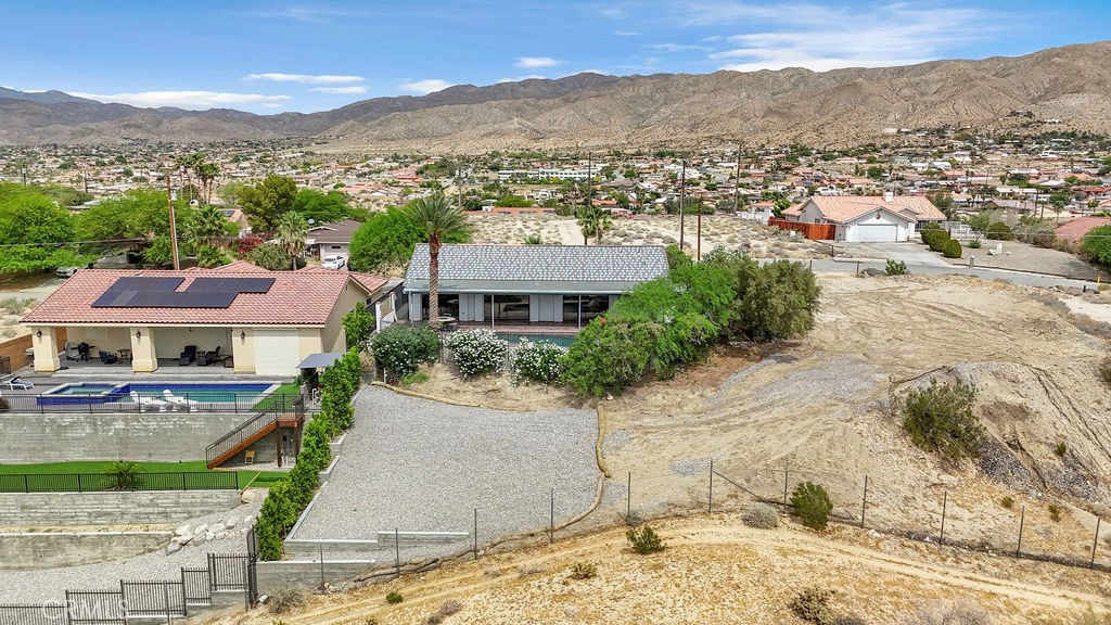 67525 Monterey Road Desert Hot Springs, CA 92240 - Photo 66 of 75 an aerial view of residential houses with outdoor space and trees
