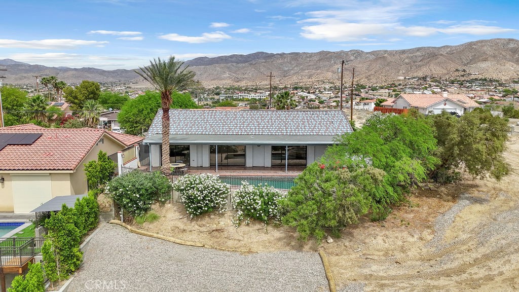 67525 Monterey Road Desert Hot Springs, CA 92240 - Photo 69 of 75 aerial view of a house with a yard and balcony