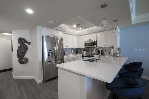 a large bed sitting in a bedroom next to a window with a large window