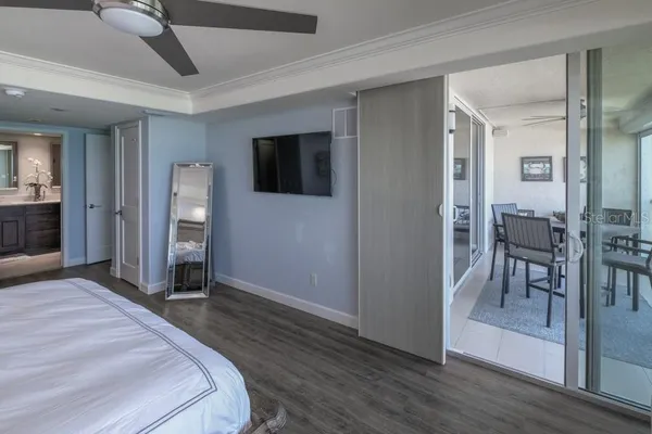 a bedroom with a bed and a chandelier