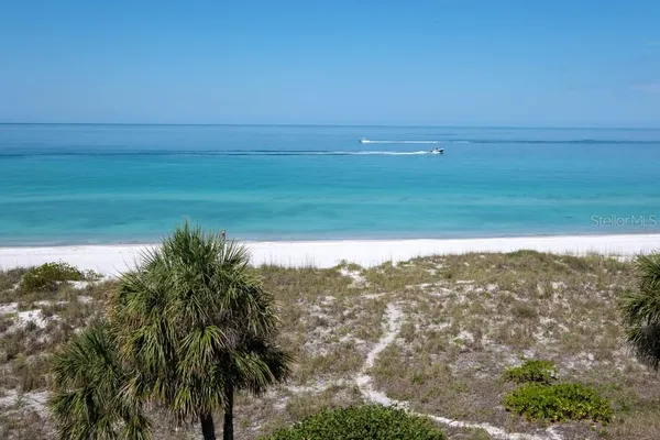 a living room with furniture kitchen view and a window