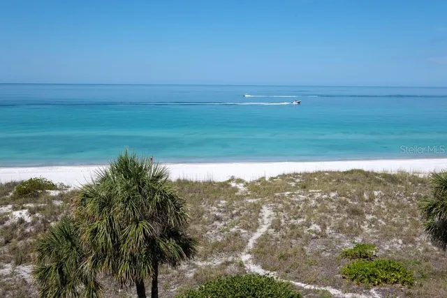 a living room with furniture kitchen view and a window