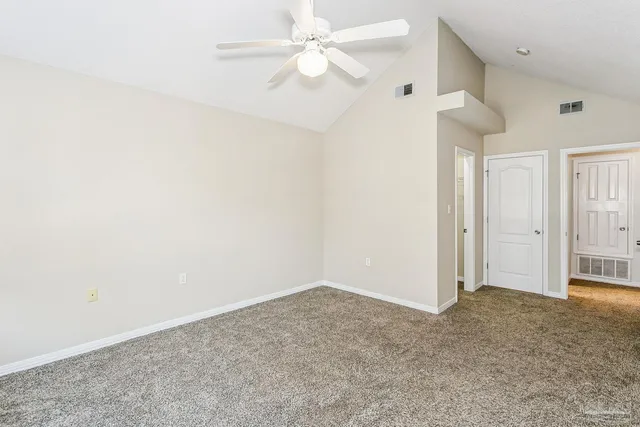 an empty room with a ceiling fan and a ceiling fan