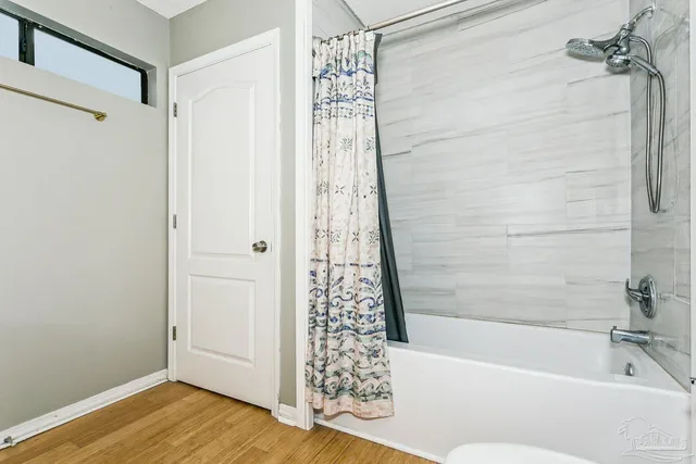 a bathroom with a bathtub and shower