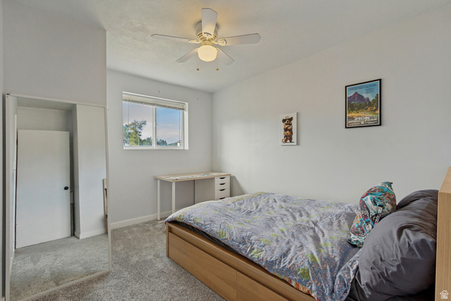 730 Geranium Street Sandy, UT 84094 - Photo 18 of 35 Recessed window with a white frame, overhead ceiling fan with lighting, light-toned carpeting, and a built-in closet with mirrored sliding doors