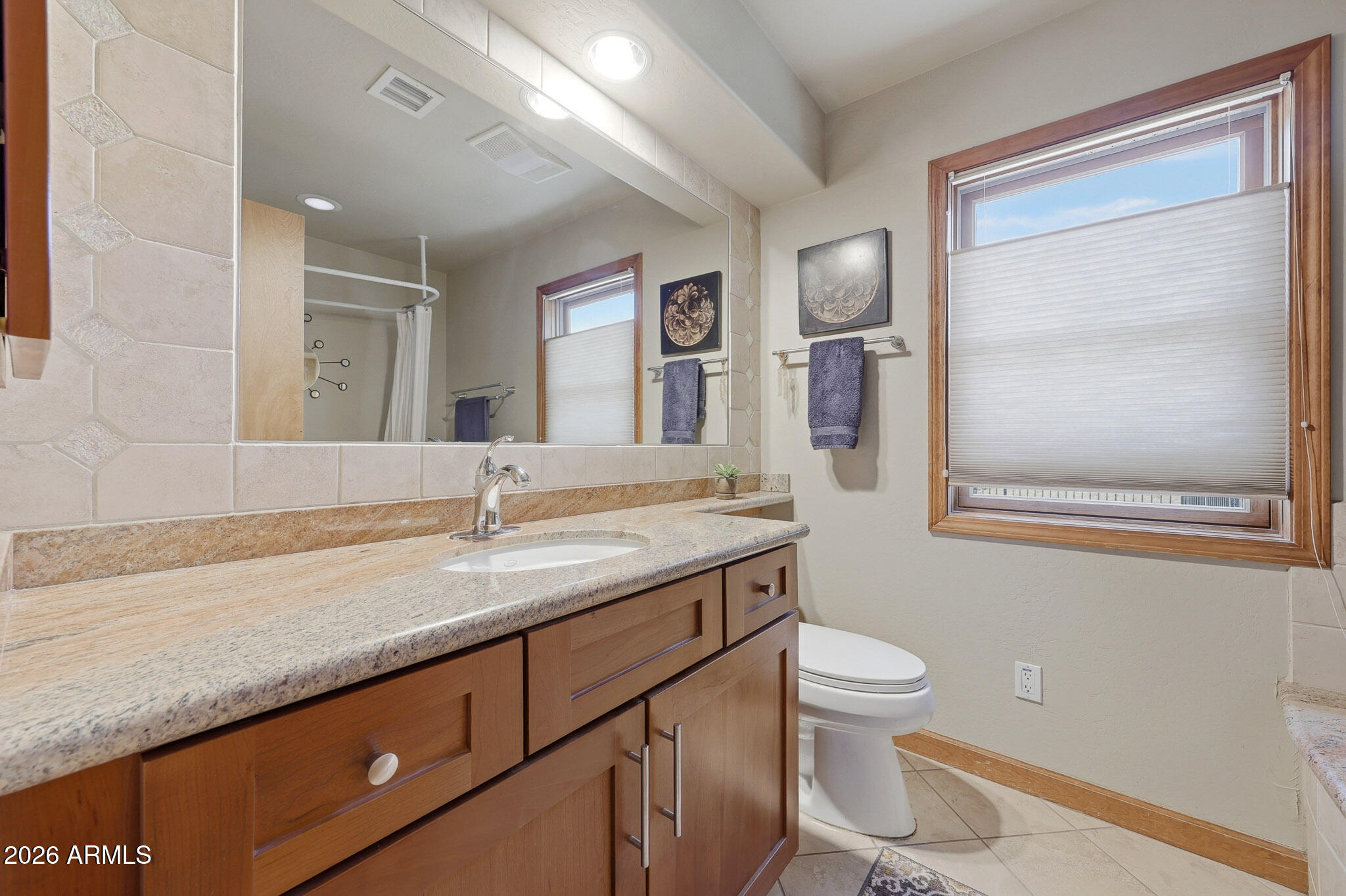 6019 East Blue Ridge Drive Cave Creek, AZ 85331 - Photo 25 of 49 a bathroom with a granite countertop sink a toilet and mirror