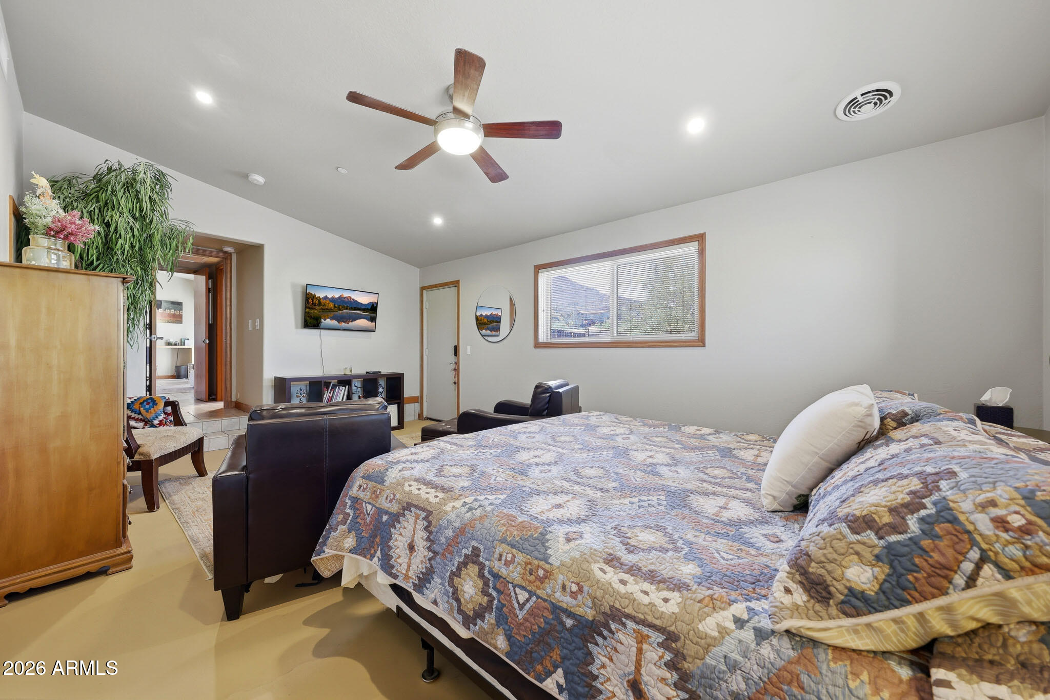 6019 East Blue Ridge Drive Cave Creek, AZ 85331 - Photo 27 of 49 a bedroom with a large bed and a chandelier