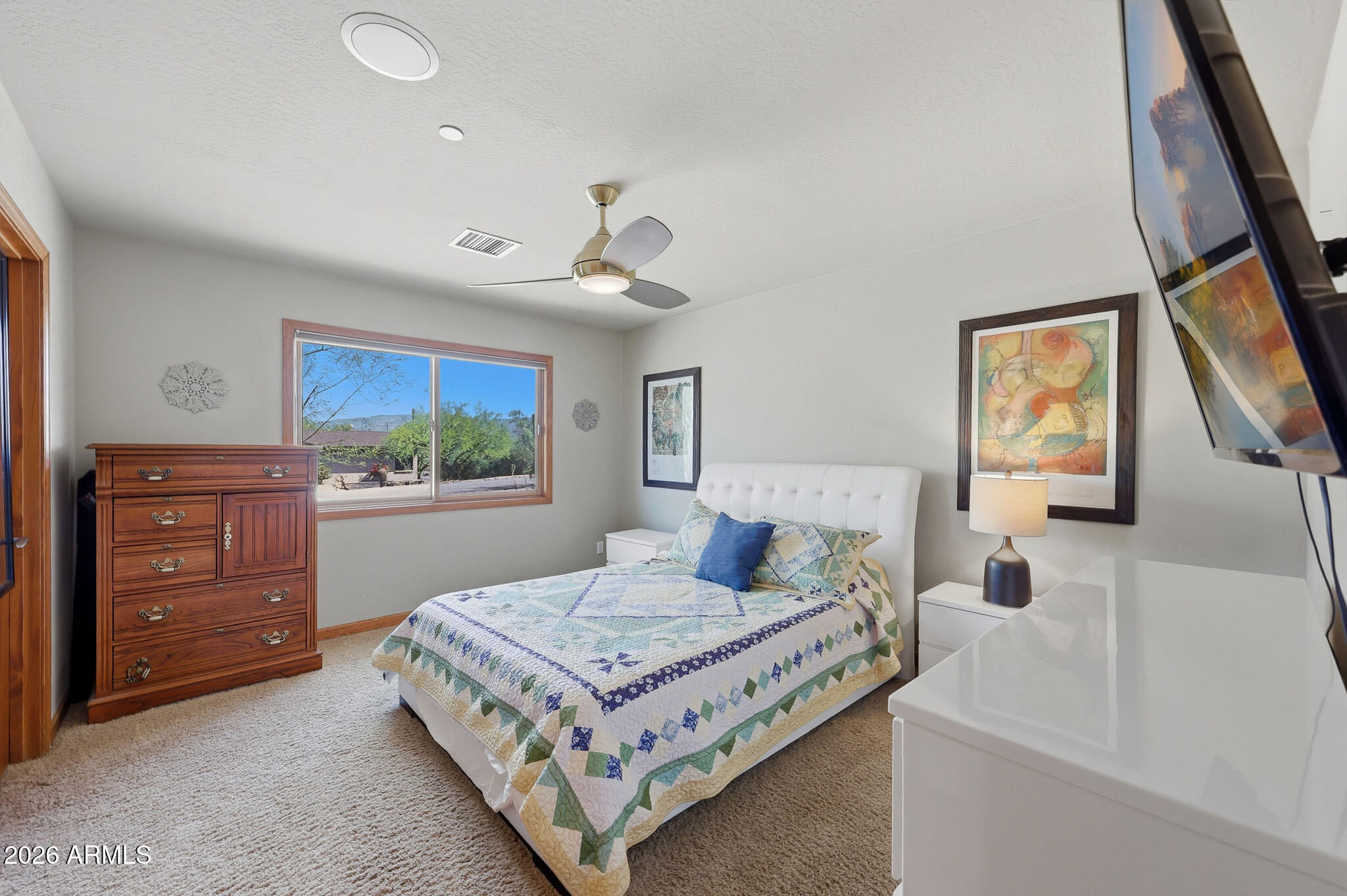 6019 East Blue Ridge Drive Cave Creek, AZ 85331 - Photo 29 of 49 a bedroom with a large bed and a flat tv screen on dresser