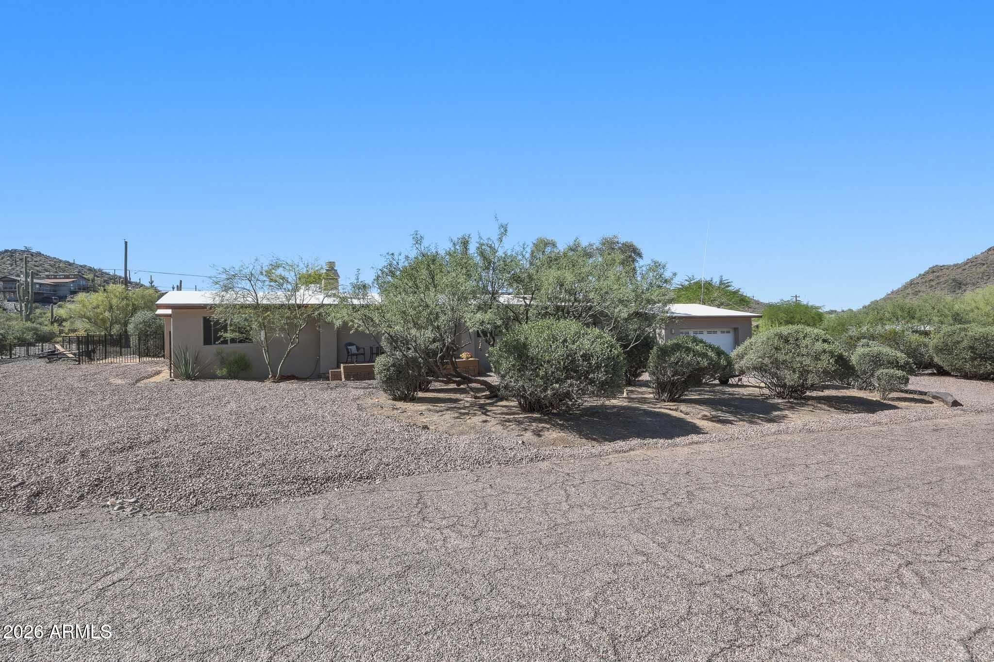 6019 East Blue Ridge Drive Cave Creek, AZ 85331 - Photo 3 of 49 a view of a dry yard with trees