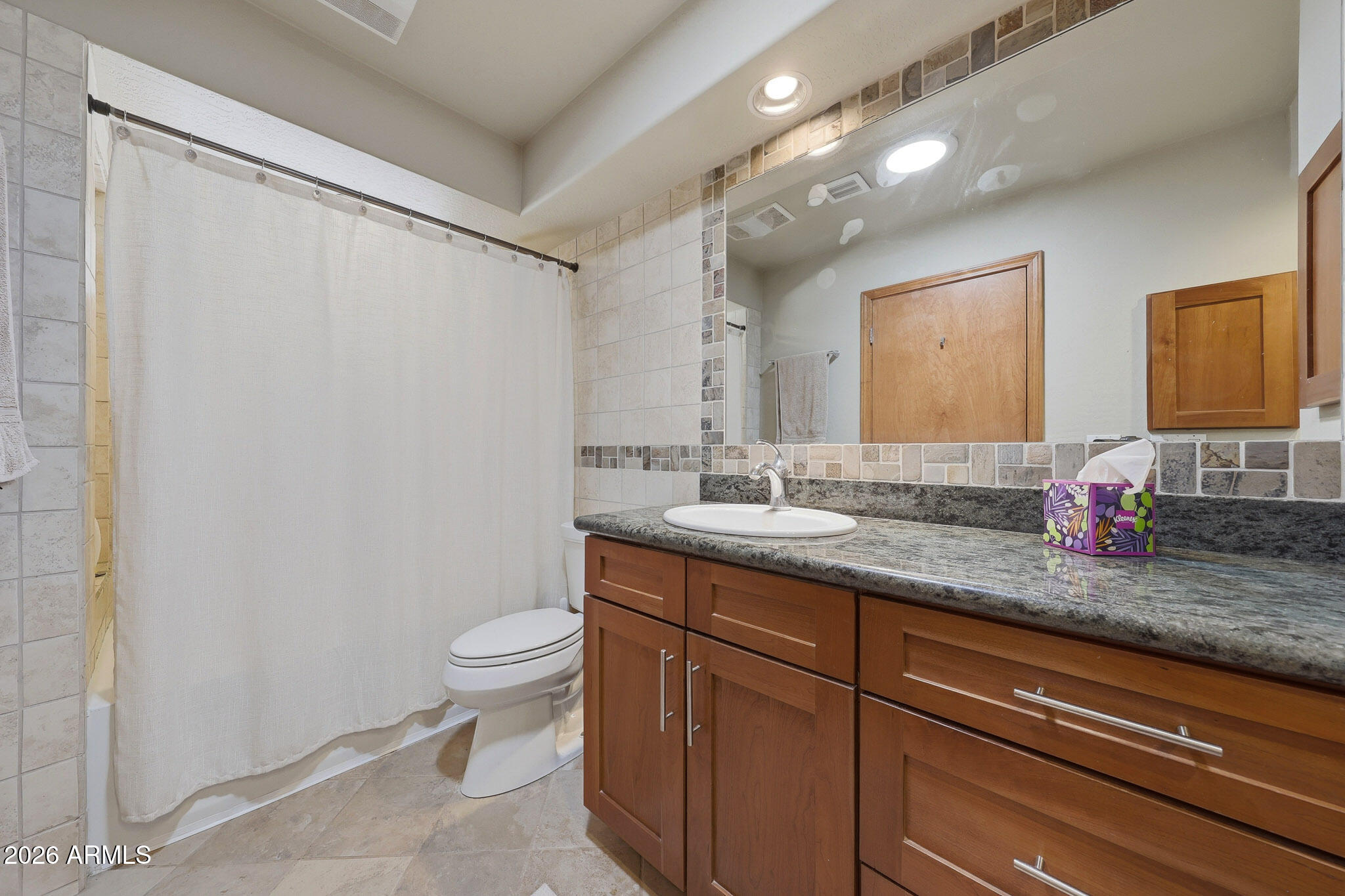 6019 East Blue Ridge Drive Cave Creek, AZ 85331 - Photo 35 of 49 a bathroom with a granite countertop sink a toilet and a mirror